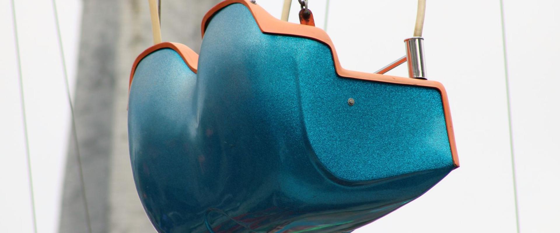 Close-up of a colorful swing ride at a Dutch amusement park, focusing on vibrant design.